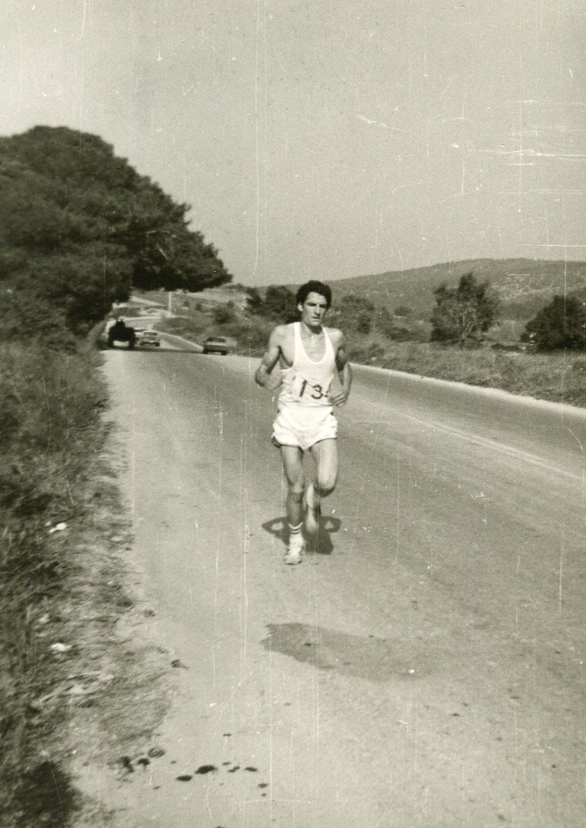 Historic black-and-white photo of George Afordakos running